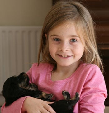 Girl holding puppy